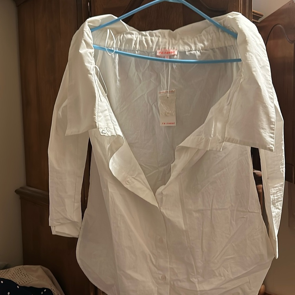 New with tag still on white shirt